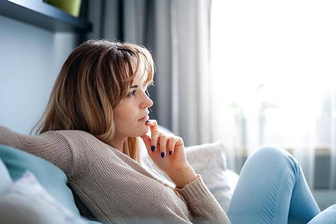 Woman thinking on a couch